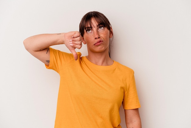 Young Argentinian woman isolated on white background showing a dislike gesture, thumbs down. Disagreement concept.