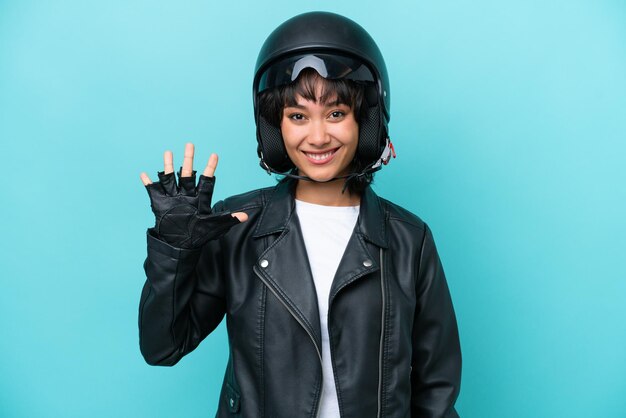 Young Argentinian woman with a motorcycle helmet isolated on blue background counting five with fingers