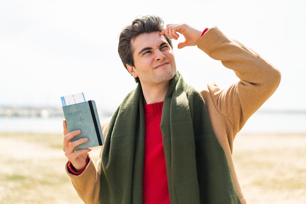 Young artist caucasian man holding a palette isolated on red background making stop gesture