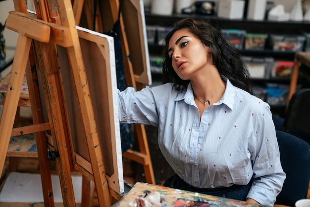 Young artist working on a painting at the studio