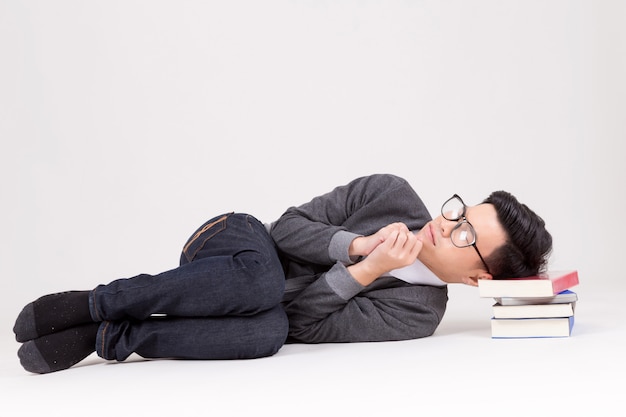 Young Asia graduate student sleep with his book