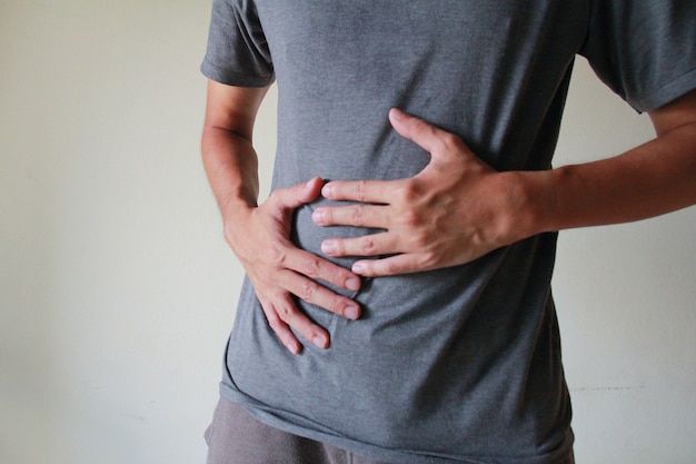 young asia man is having stomach ache.