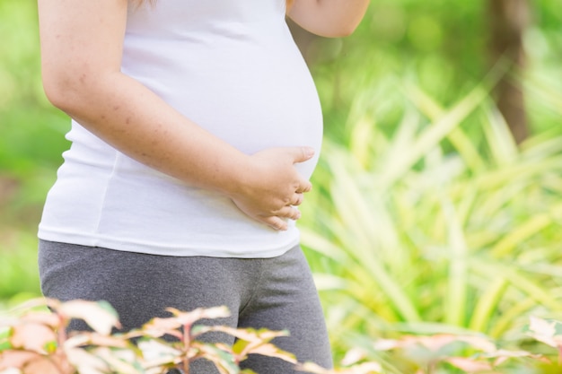 Young Asia pregnant in beautifull garden