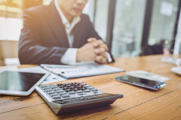 Young Asian accountant businessman working with financial bill.