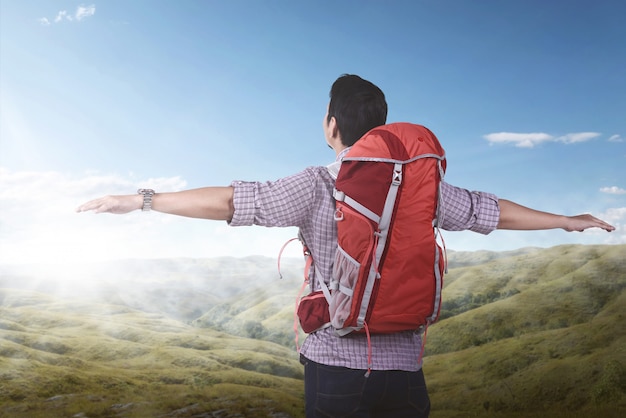 Young asian backpacker enjoying the landscape 