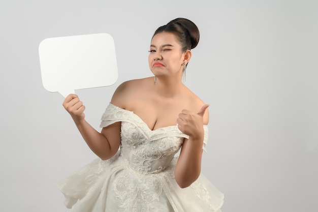 Young asian beautiful bride pose with mockup banner in hand