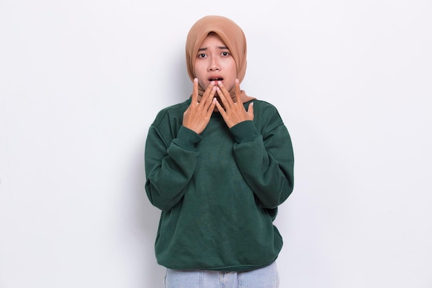 Young asian beautiful muslim woman shocked covering mouth with hands for mistake isolated on white