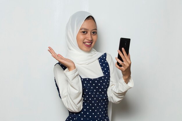 Young asian beautiful muslim woman using mobile phone