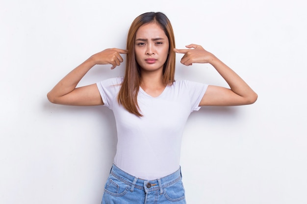 Young asian beautiful woman covering both ears with hands isolated on white background