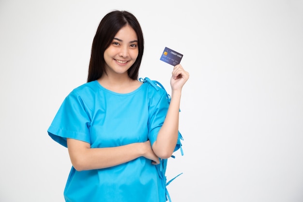 Young Asian beautiful woman patient showing credit card isolated, Insurance policy by bank concept