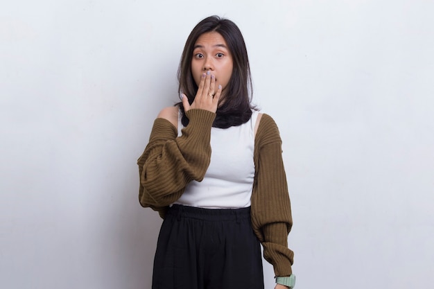 Young asian beautiful woman shocked covering mouth with hands for mistake on white background