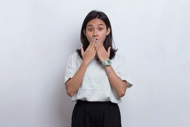 Young asian beautiful woman shocked covering mouth with hands for mistake on white background