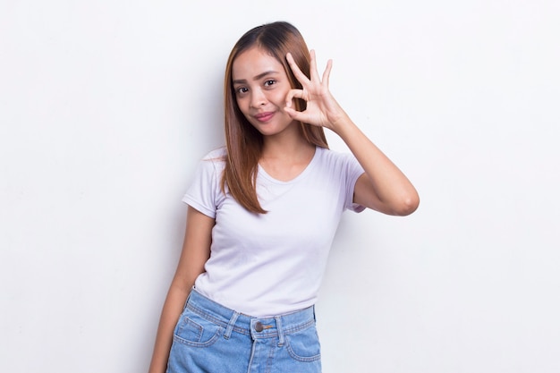 Young asian beautiful woman with ok sign gesture tumb up isolated on white background