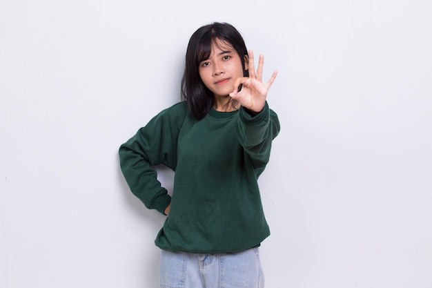 young asian beautiful woman with ok sign gesture tumb up isolated on white background