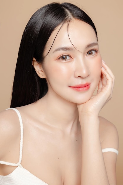 Photo young asian beauty woman long hair with korean makeup style on face and perfect skin on isolated beige background facial treatment cosmetology plastic surgery