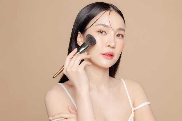 Young asian beauty woman long hair with korean makeup style on face and perfect skin using brush