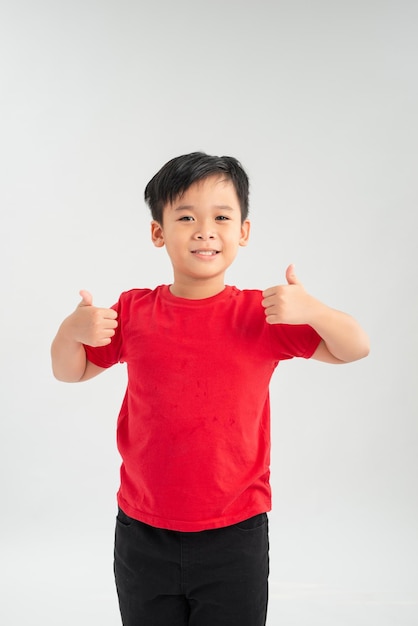 Young Asian boy showing thumb isoalte on white background