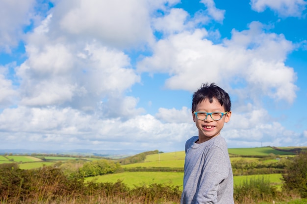 Young asian boy smiling at field 