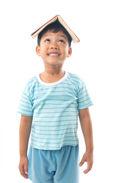 Young Asian boy student putting  book and show over head