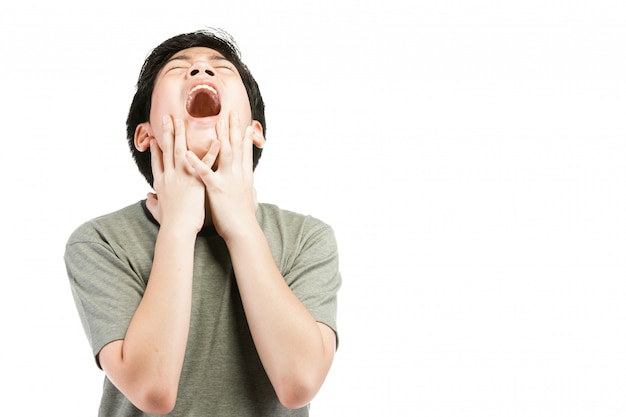 Young Asian boy over white background, be upset; have a bad temper emotional.