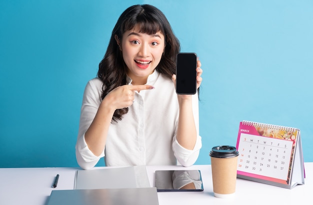 Young Asian buisness woman working on blue