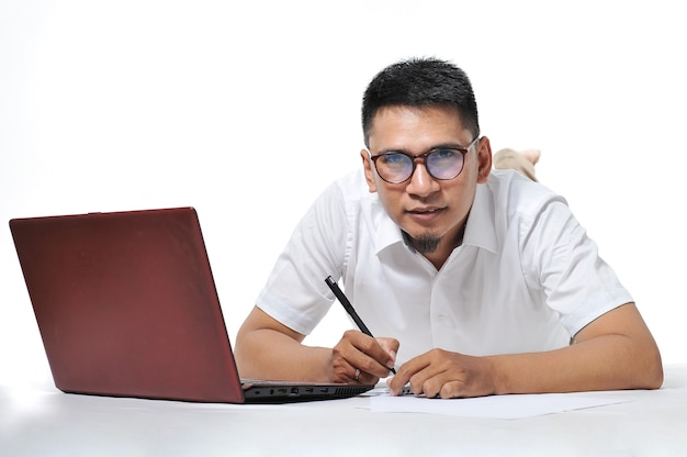 Young Asian business man/entrepreneur or freelancer laying on the floor. Freelancer Concept.