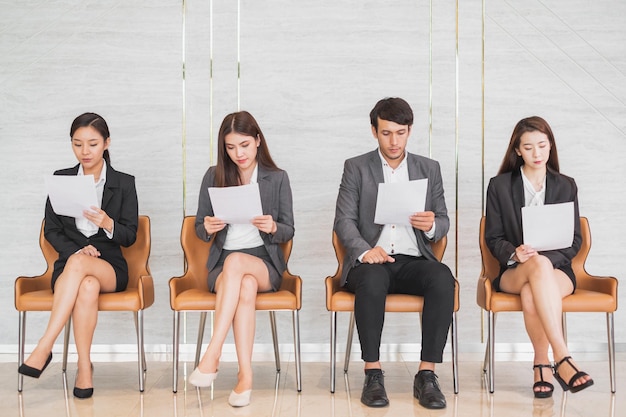 Young Asian business people waiting for job interview in office occupation and job applying concept