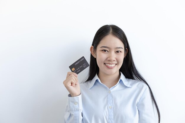 Young asian business woman holding a credit card and smiling happily