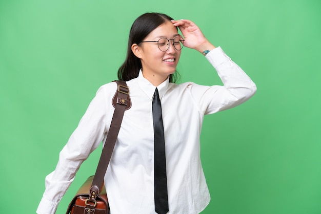 Young Asian business woman over isolated background has realized something and intending the solution