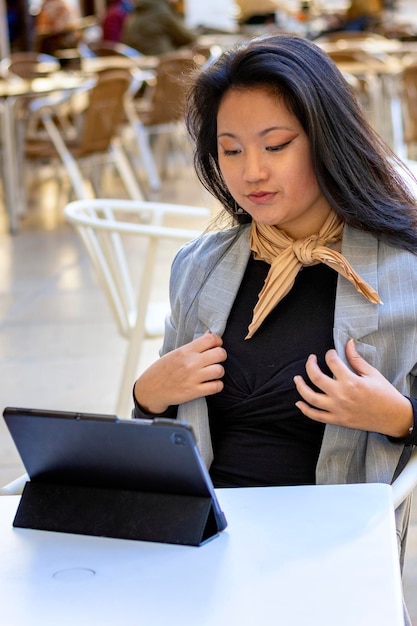 Young Asian business woman office employee using laptop watching webinar Female professional worker