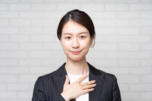 Young Asian business woman posing for guidance