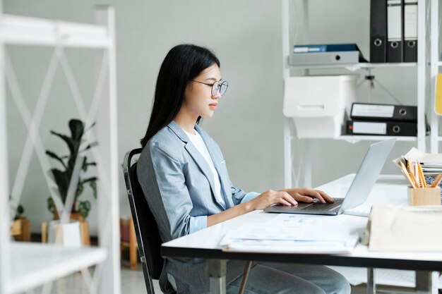 Young asian business woman or student working online on computer laptop