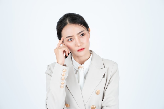 Young asian business woman in white shirt and beige suit