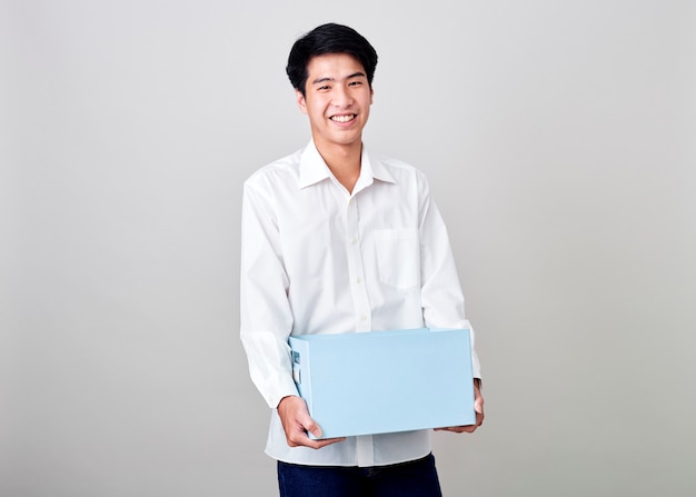 Young asian businessman holding a box