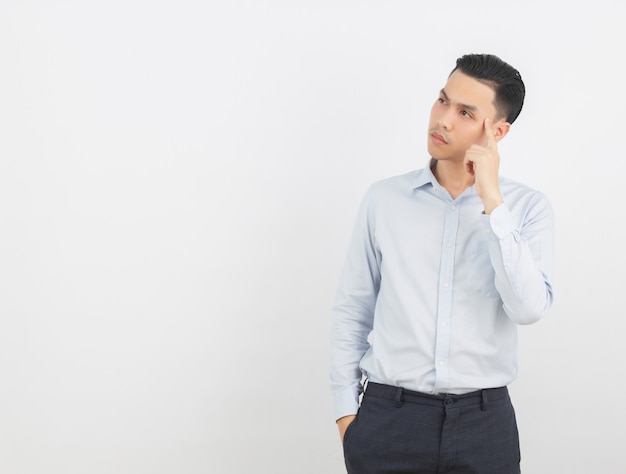 Young asian businessman pointing with a finger to present a product or an idea 