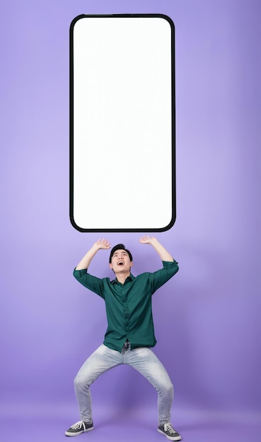 Young Asian businessman on purple background