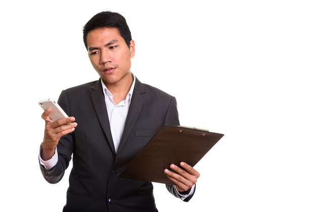  young Asian businessman using mobile phone