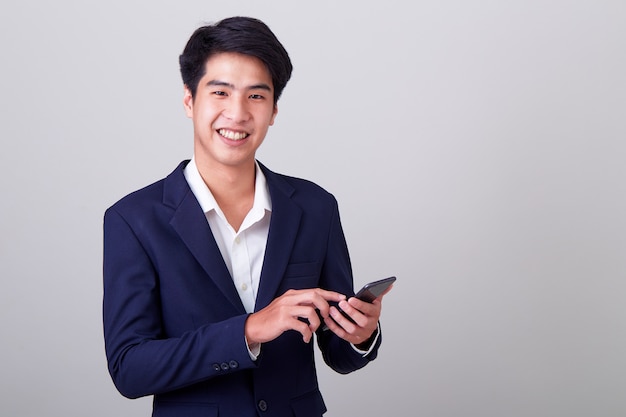 Young asian businessman using a smart phone