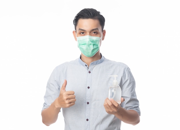 Young Asian Businessman wearing hygienic mask and holding hand sinitizer, Prevent infection, coronavirus. Airborne respiratory illness such as pm 2.5 fighting and flu isolated on white.