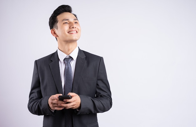 young Asian businessman wearing suit on white