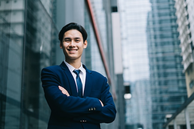 Young asian businessman with glass building