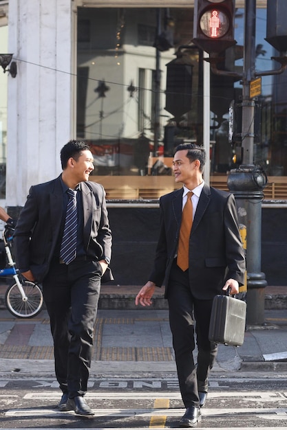 Young Asian businessmen zebra crossing going to the office