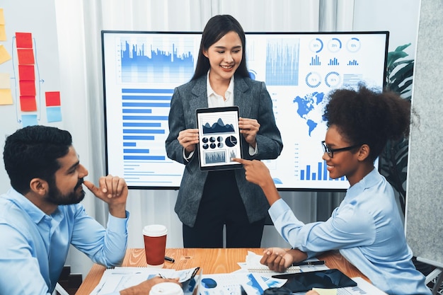 Young asian businesswoman presenting data analysis dashboard on TV Concord