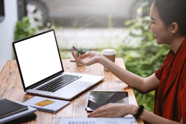 Young Asian businesswoman sitting at the office with a laptop with documents and credit cards placed at the office.