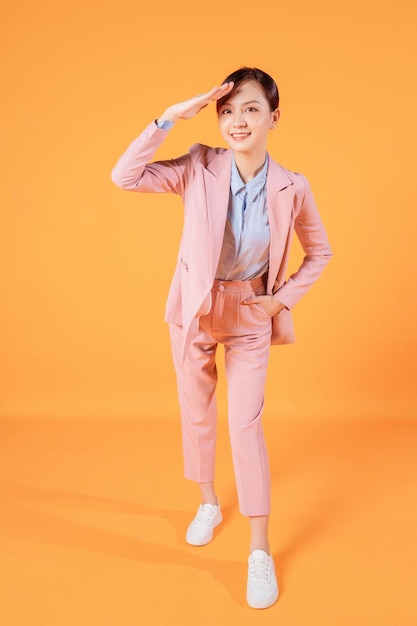 Young Asian businesswoman standing on background