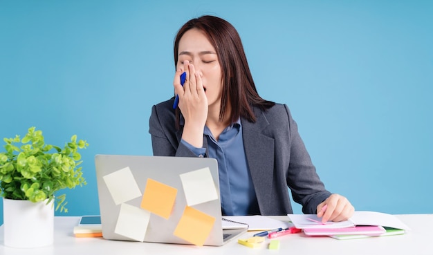 Young Asian businesswoman working on background