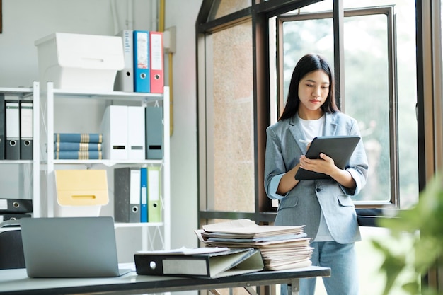 Young asian businesswoman working at office using laptop