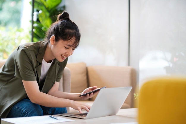 Young asian businesswoman working at office using mobile phonexA