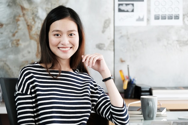 사무실 책상, 긍정적 인 감정, 사무실 생활 개념에 웃는 얼굴로 작업하는 젊은 아시아 사업가
