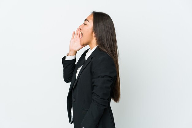 Young asian bussines woman isolated on white shouting and holding palm near opened mouth.